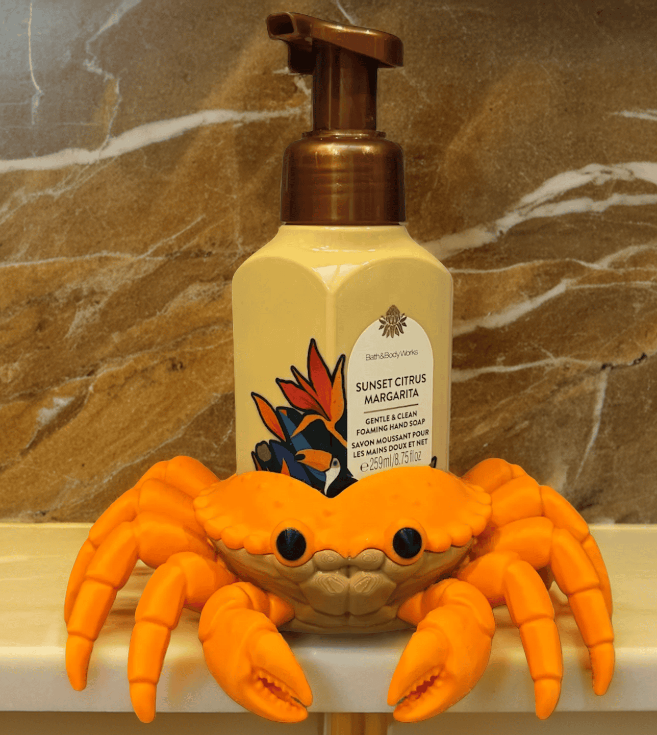 Bright orange crab toy with sunset citrus hand soap bottle behind it. Acadiana3DPrints