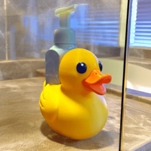 Yellow rubber ducky soap dispenser on bathroom counter. Acadiana3DPrints