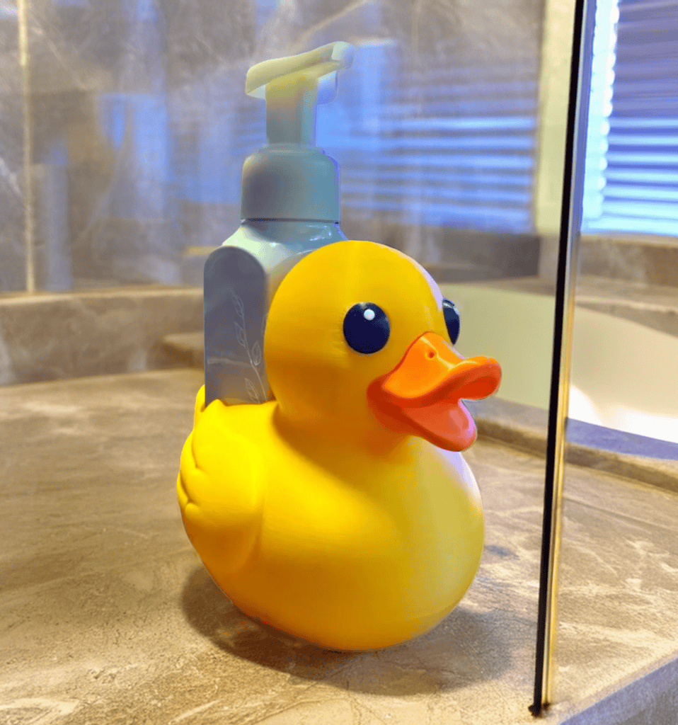 Yellow rubber ducky soap dispenser on bathroom counter. Acadiana3DPrints