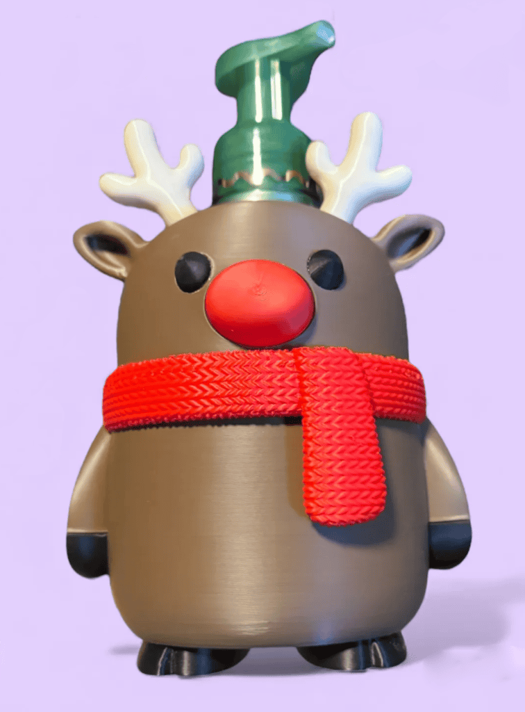 Cute reindeer figurine with red nose, antlers, and a green hat for Christmas decor. Acadiana3DPrints