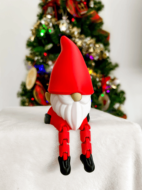 Cute Santa gnome with red hat and black boots in front of Christmas tree. Acadiana3DPrints