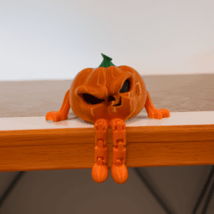 Halloween pumpkin figurine with a mischievous face and orange limbs. Acadiana3DPrints