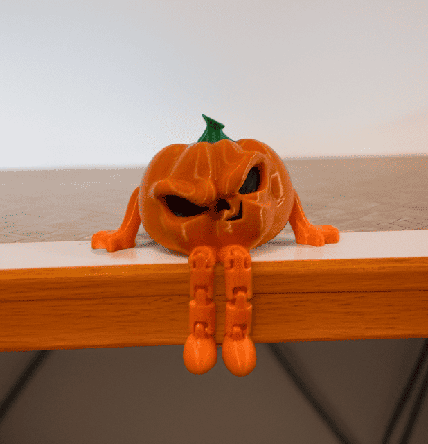 Halloween pumpkin figurine with a mischievous face and orange limbs. Acadiana3DPrints